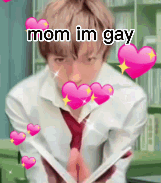 a boy in a white shirt and tie is holding a book with pink hearts around him and the words mom im gay above him