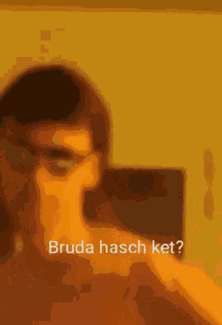 a blurry picture of a man 's face with the words bruda hasch ket written in the corner .