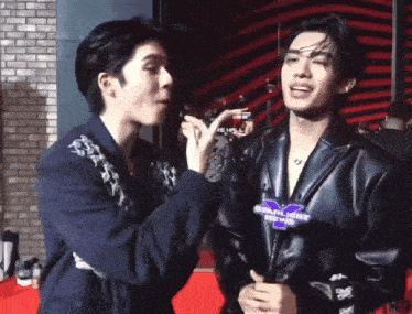 a man wearing a jacket that says starlight news talks to another man