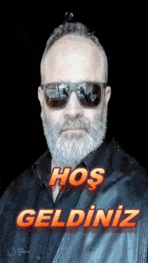 a man with a beard wearing sunglasses and a black shirt says hos geldiniz