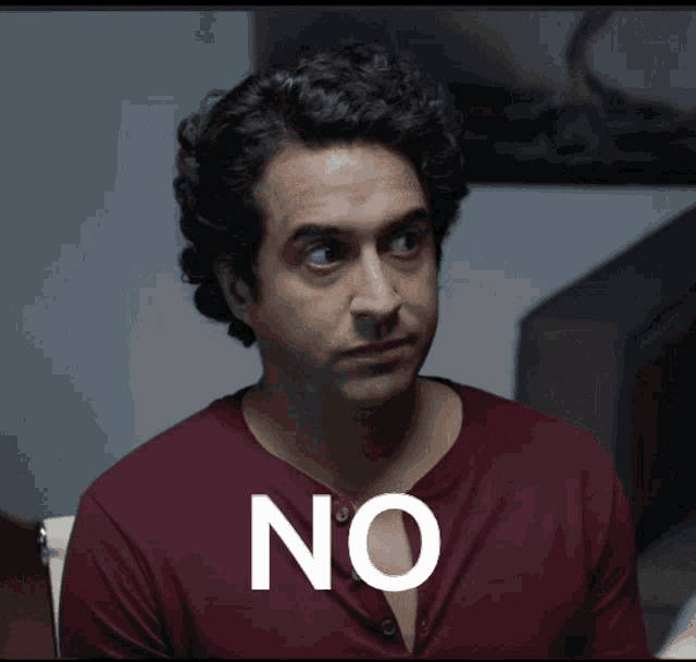 a man wearing a red shirt with the word no on his chest