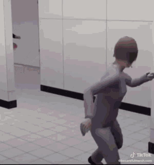 a man wearing a pink tutu is running down a hallway .