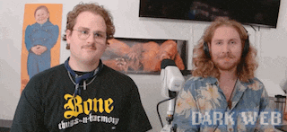 two men are standing next to each other in front of a microphone wearing headphones and a shirt that says bone