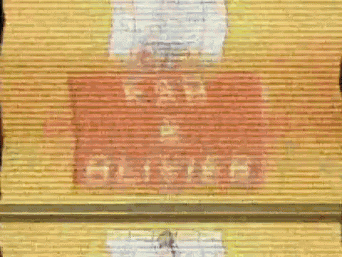 a yellow wall has a red sign that says kad & olivier