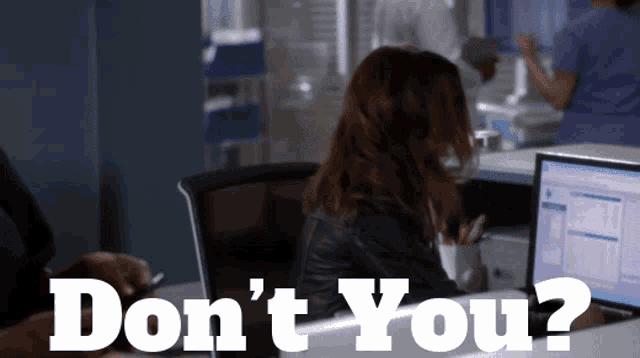 a woman sits at a desk with the words " don 't you " written on it