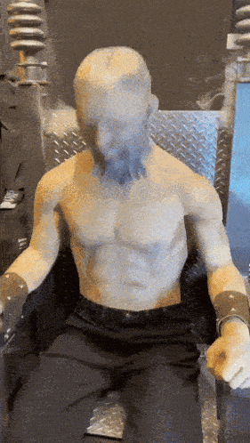 a statue of a man with a beard sitting in a chair