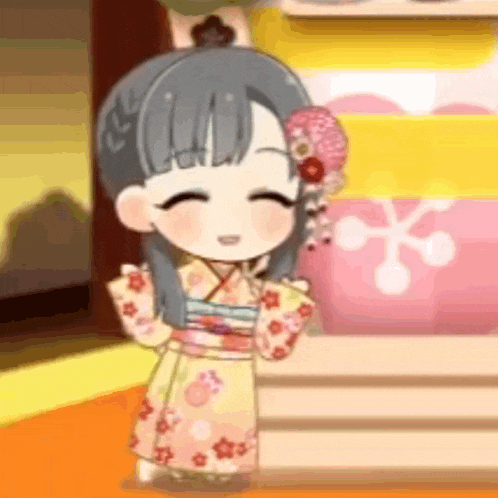 a little girl is wearing a kimono and smiling while standing in a room .