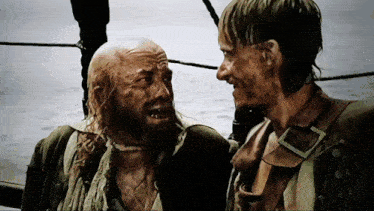 a man with a beard is talking to another man on a ship