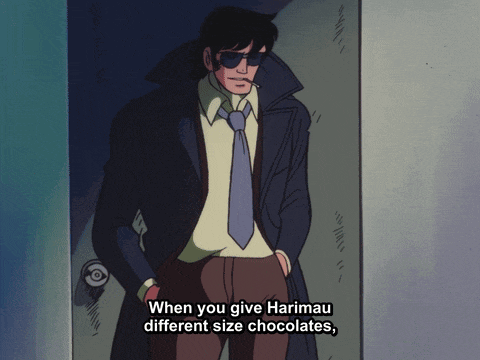 a man in a suit and tie is standing in a doorway and says when you give harimau different size chocolates