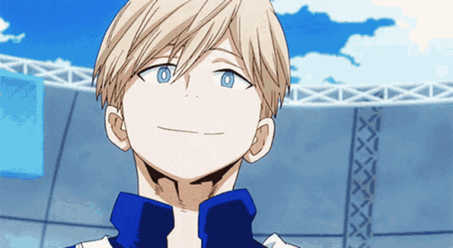 a young boy with blonde hair and blue eyes is smiling
