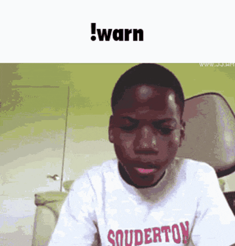 a young boy wearing a shirt that says souderton is making a funny face