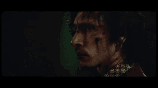 a man with blood on his face is talking to another man who says " what the fuck "