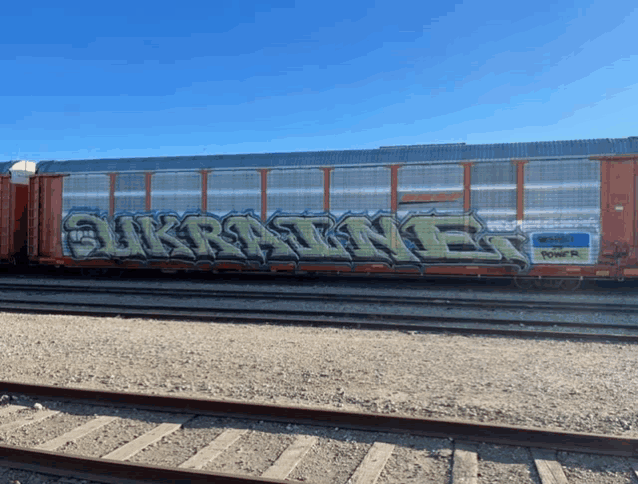 a train car with graffiti on the side that says sunrise
