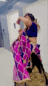a blurry picture of a woman in a purple saree and a blue blouse .