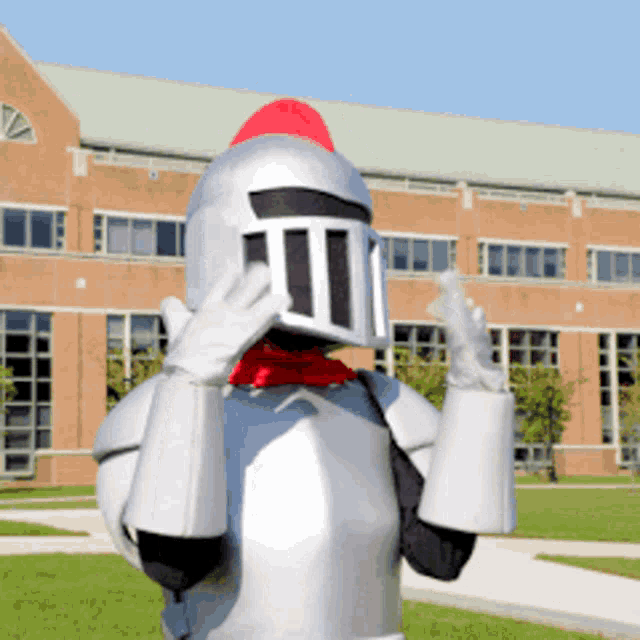 a person dressed as a knight is standing in front of a building