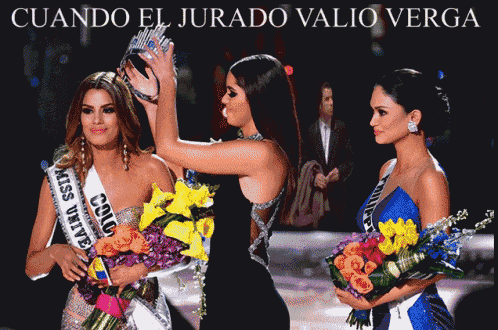 a miss universe contestant is being crowned by two other women
