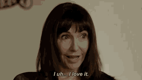 a woman is smiling and saying i love it .