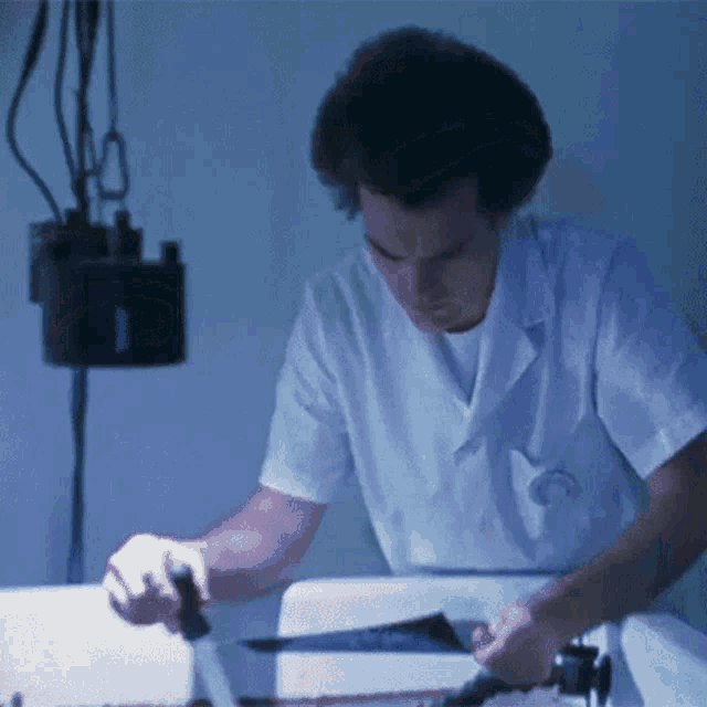 a man in a lab coat is working on a machine