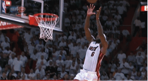 a basketball player with the number 6 on his jersey is jumping for the ball
