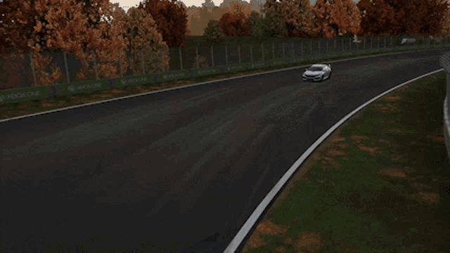 a white car with red brake pads is driving down a dark road