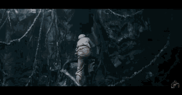 a man is chained to a tree in the woods