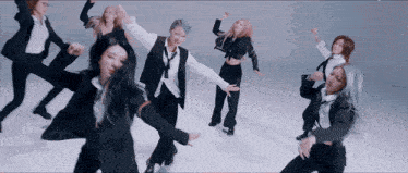 a group of women in suits are dancing together on a white background