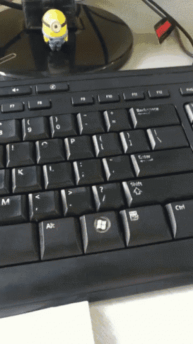 a keyboard with a minion on top of it