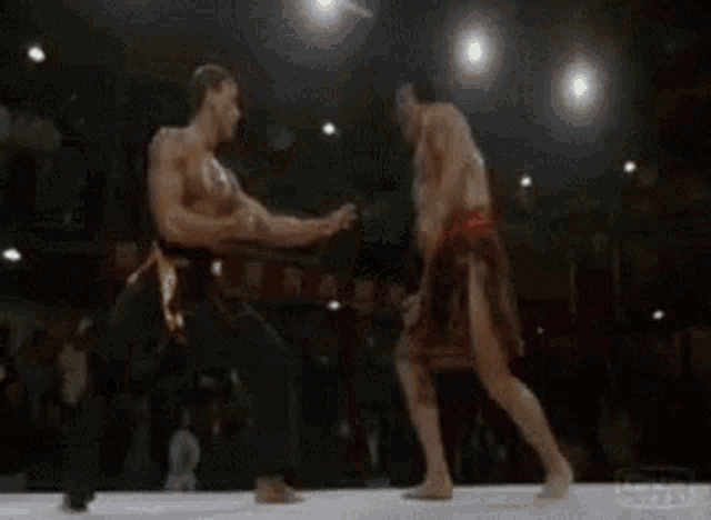 a man is kneeling down next to a woman in a ring .