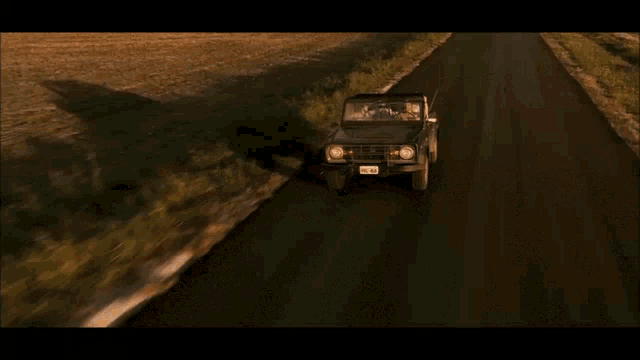 a car with a license plate that says pre 68 drives down a road