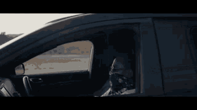 a man and a woman are sitting in a car
