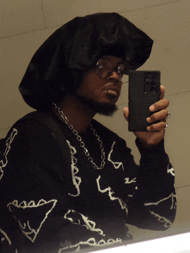 a man taking a picture of himself with a cell phone