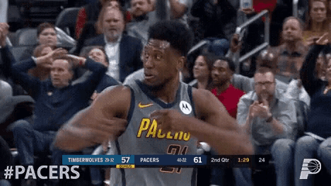 a basketball player wearing a pacers jersey is standing in front of a crowd