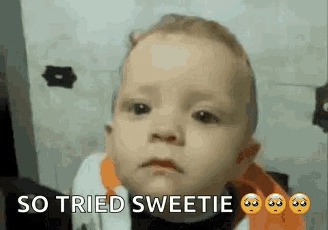 a baby is making a sad face with the words so tried sweetie written below it .