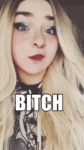 a woman with long blonde hair is wearing a black and white shirt and says bitch
