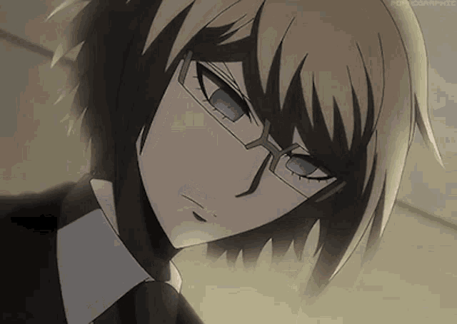 a close up of a boy wearing glasses and a suit .