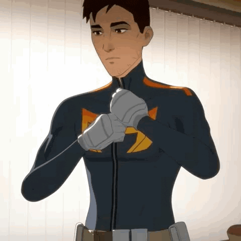 a man in a superhero costume is putting on his gloves in front of a window .