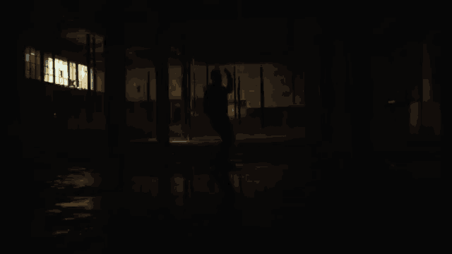 a person is standing in a dark room surrounded by blue lights