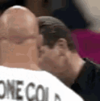 a man with a bald head is wearing a white shirt that says one could .