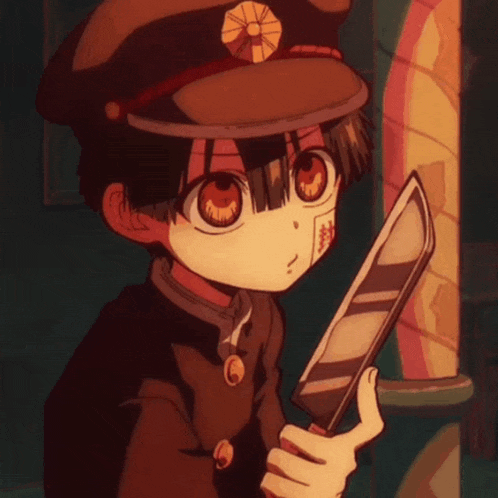 a boy in a hat is holding a large knife