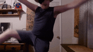 a man with his arms outstretched is wearing a hat