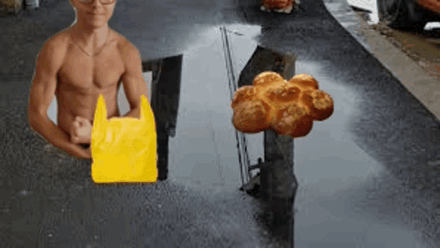 a shirtless man holding a yellow bag next to a bunch of bread in a puddle