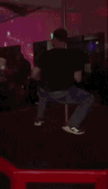 a blurry picture of a man dancing in a dark room