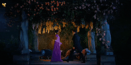 a man and a woman are kissing under a tree .