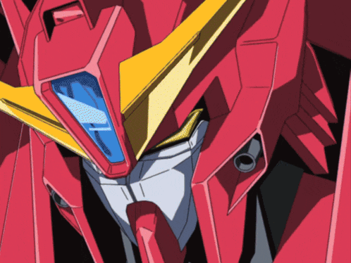 a close up of a red robot with a yellow wing