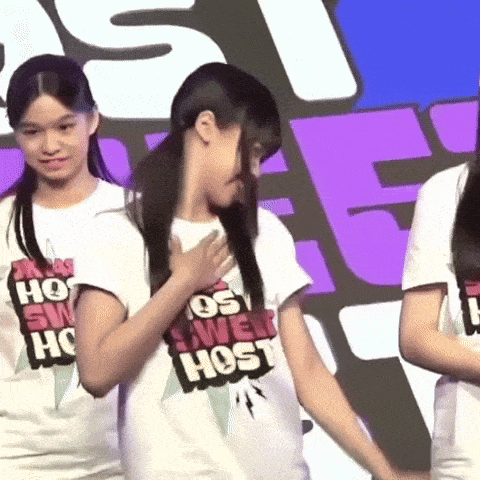 a girl in a white shirt that says sweet host on it