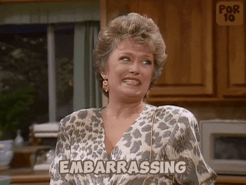 a woman in a leopard print shirt is making a funny face and the word embarrassing is on her shirt
