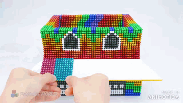 a person is making a house out of magnets