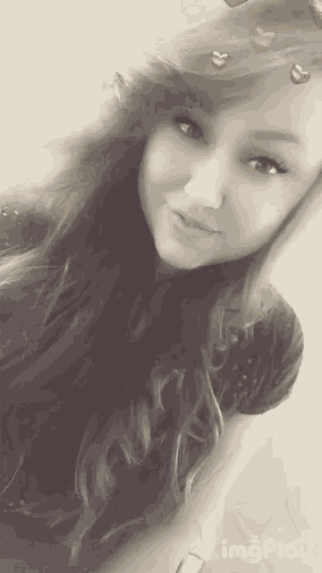 a black and white photo of a girl with hearts on her head