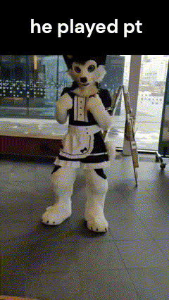 a husky mascot in a maid costume is standing on a tiled floor .