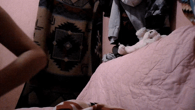 a person is laying on a bed with a blanket that says ' l ' on it